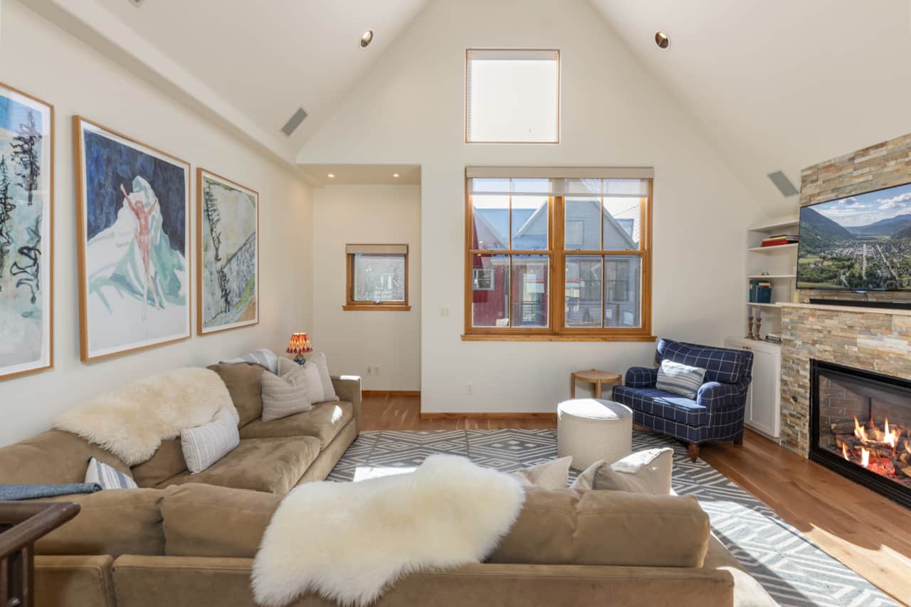 The open sitting area features plenty of seating, flat screen TV and light