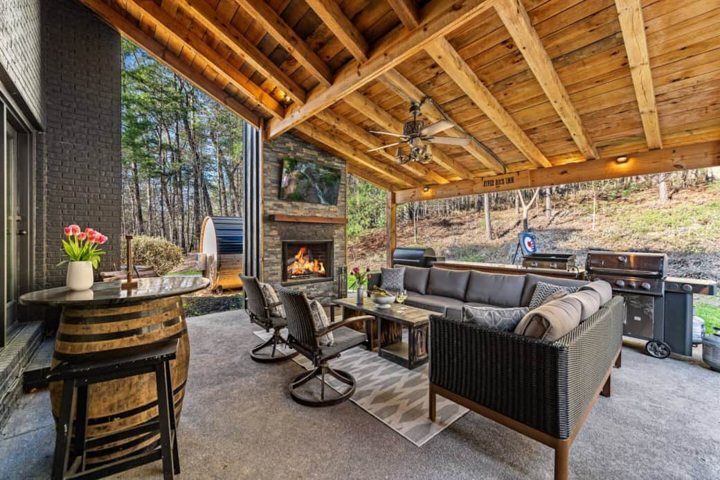 Covered patio with fireplace, TV, and Outdoor Kitchen including Traeger, Blackstone, and Weber Grill