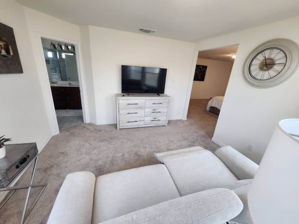 Electric reclining seating in primary bedroom facing 75" TV. Electric reclining seating in primary bedroom facing 75" TV.