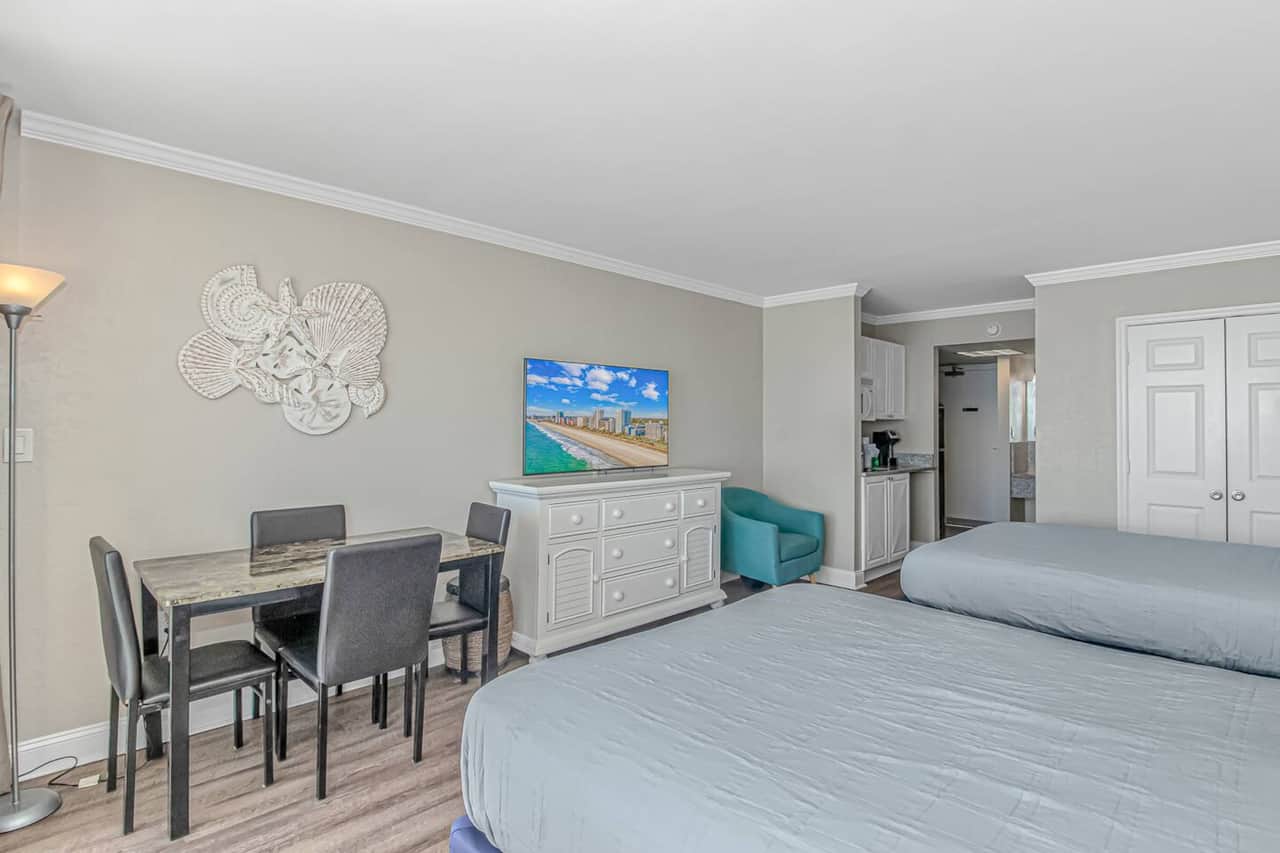 Spacious oceanfront studio with two double beds, dining for four, and room to relax after a beach day 
