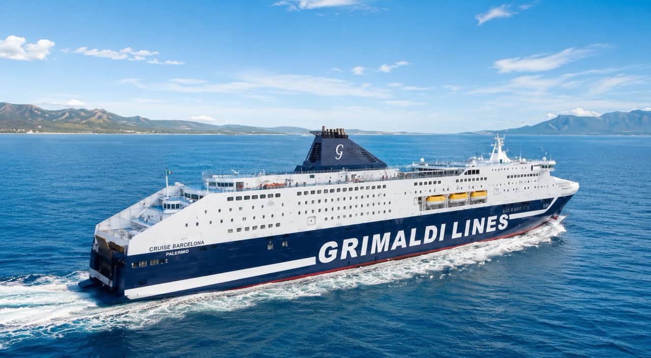 Aerial view of Grimaldi Lines ferry sailing toward Olbia, Sardinia — RENTAL12 partner discount on Livorno-Olbia route, summer 2026