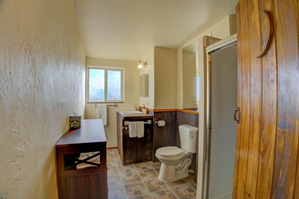 Bathroom with lots of fresh towels, Native brand soap and shampoo.