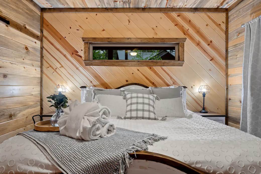 King size bed with premium bedding and pillows. Nightstands, reading lamps, smart TV, ensuite bath