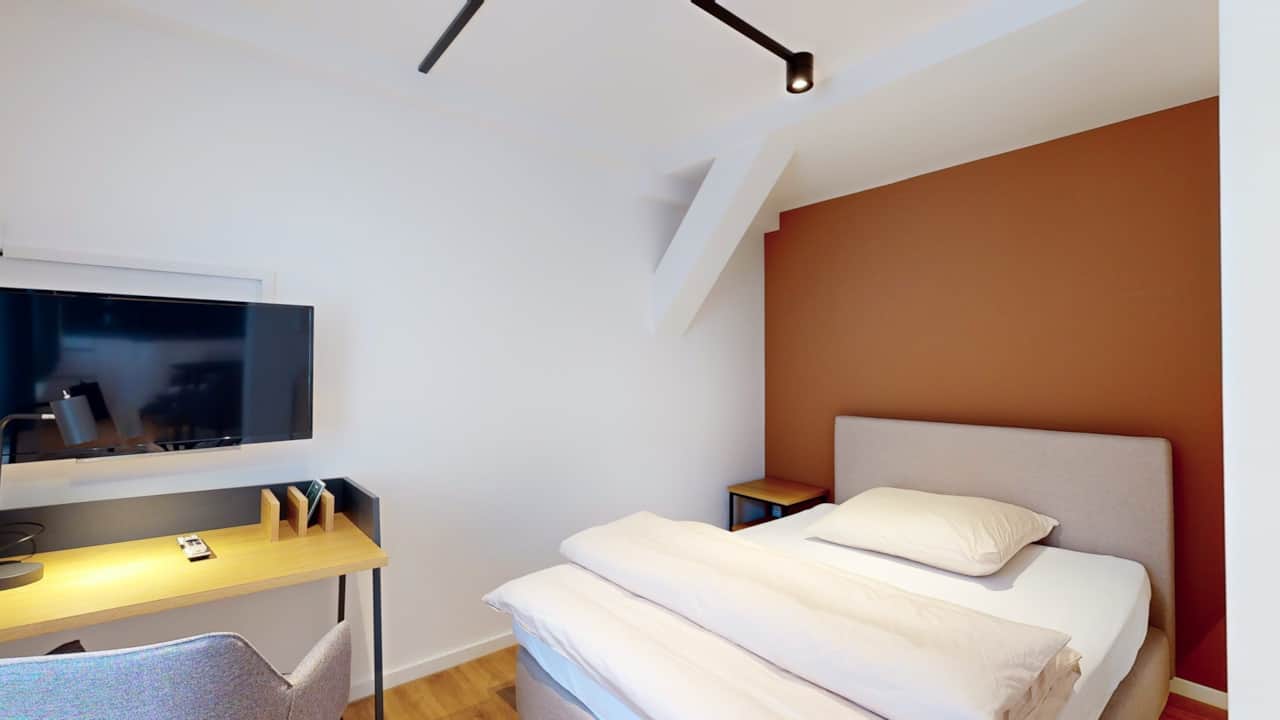Gemütliches Schlafzimmer mit Doppelbett im N°8A Boardinghouse