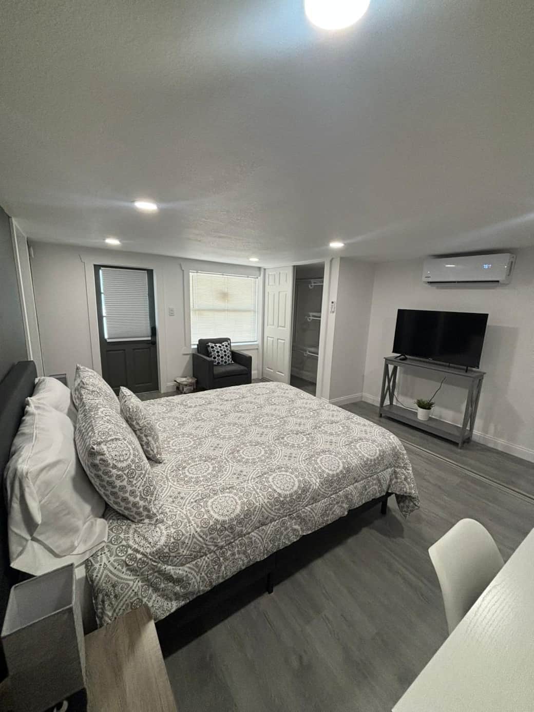 Modern room with workspace, comfy chair, and Smart TV setup. Lakeland, FL