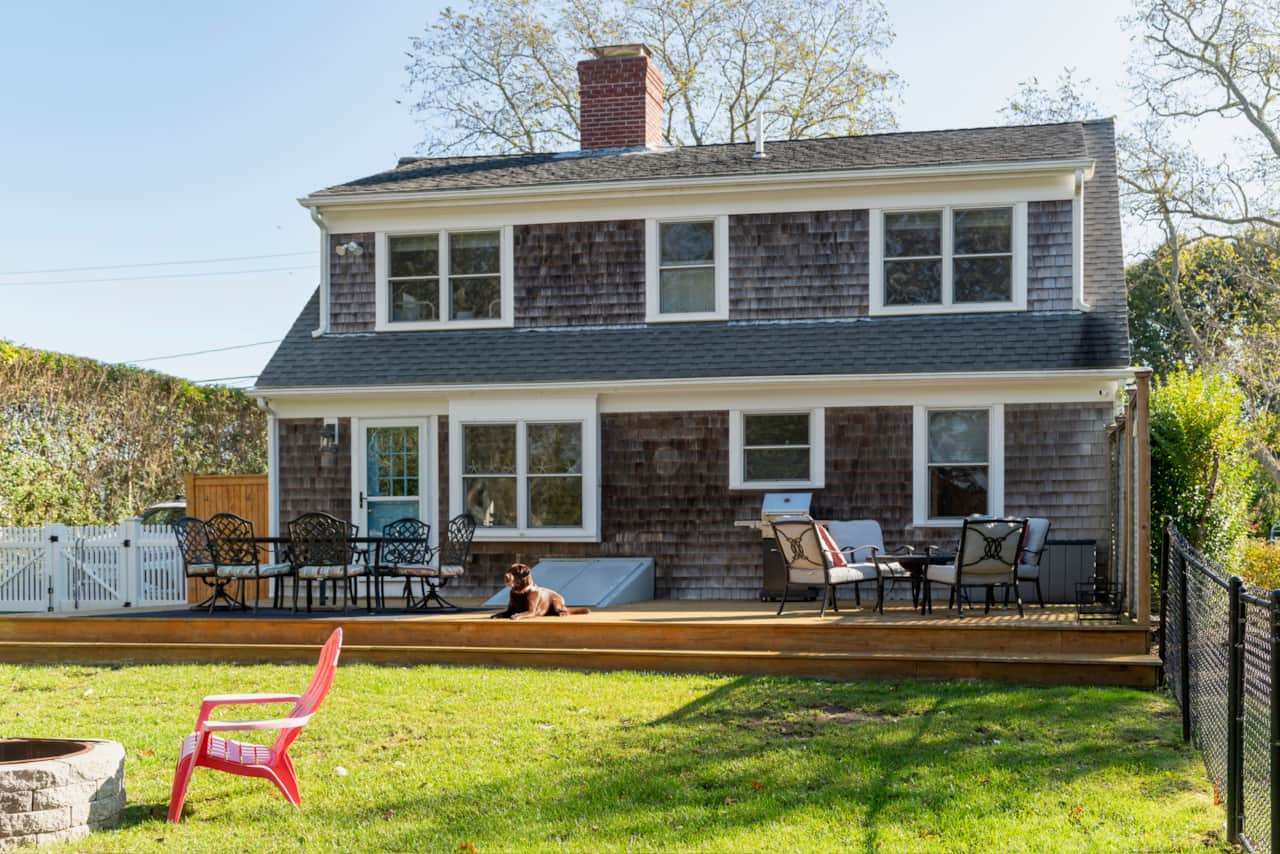 Spacious deck with BBQ and plenty seating for outdoor dining and relaxation