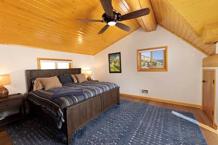 Upstairs bedroom with vaulted ceiling and mountain views