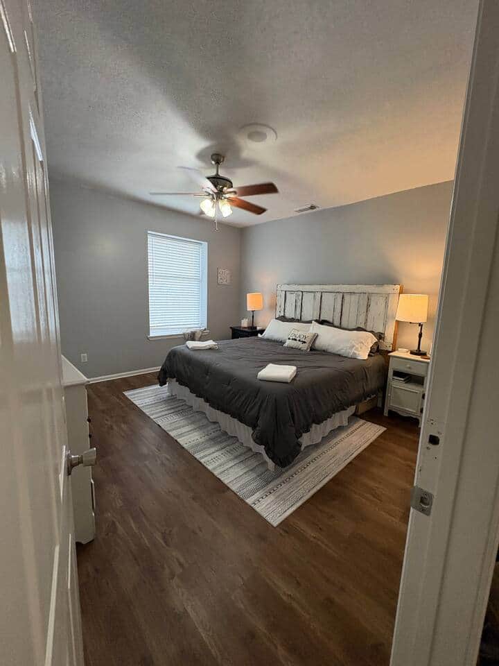 The 2nd Bedroom (Upper Level) offers lagniappe in the form of an old door repurposed as a headboard, filling this large room with rustic charm. 