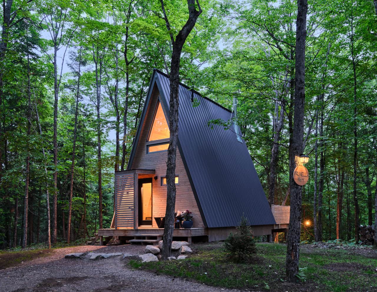 Warm, inviting, and tucked into the trees, with easy access to the lake and dock. Photo: @jvlphoto