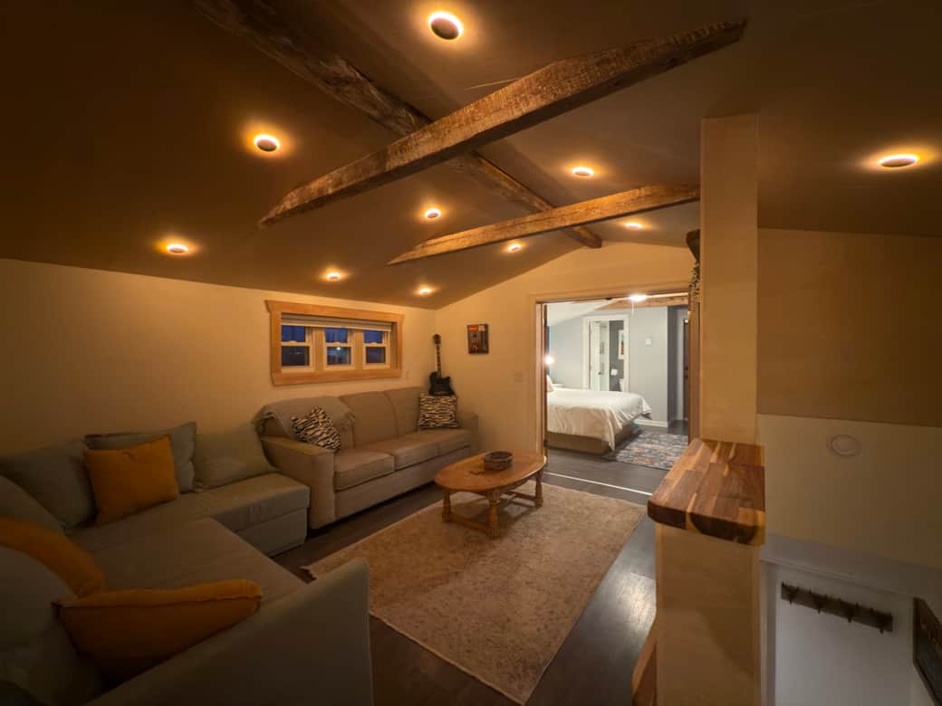 Living room from top of stairs looking toward main bedroom with lights on night mode Living room from top of stairs looking toward main bedroom with lights on night mode
