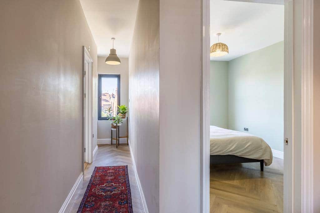 Upstairs hallway to bathroom on the left, and twin room on the right