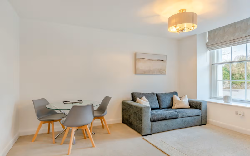 Lounge with sofa and dining table in a Lonsdale House apartment