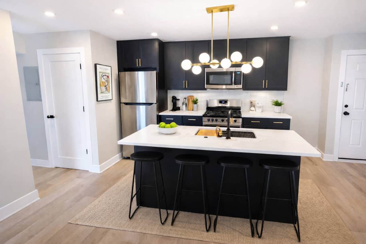 A fully equipped kitchen, including a beautiful quartz breakfast bar. You'll have access to a range with a hood, a microwave, a dishwasher, a refrigerator, and a garbage disposal, making it convenient for all your cooking and dining needs.