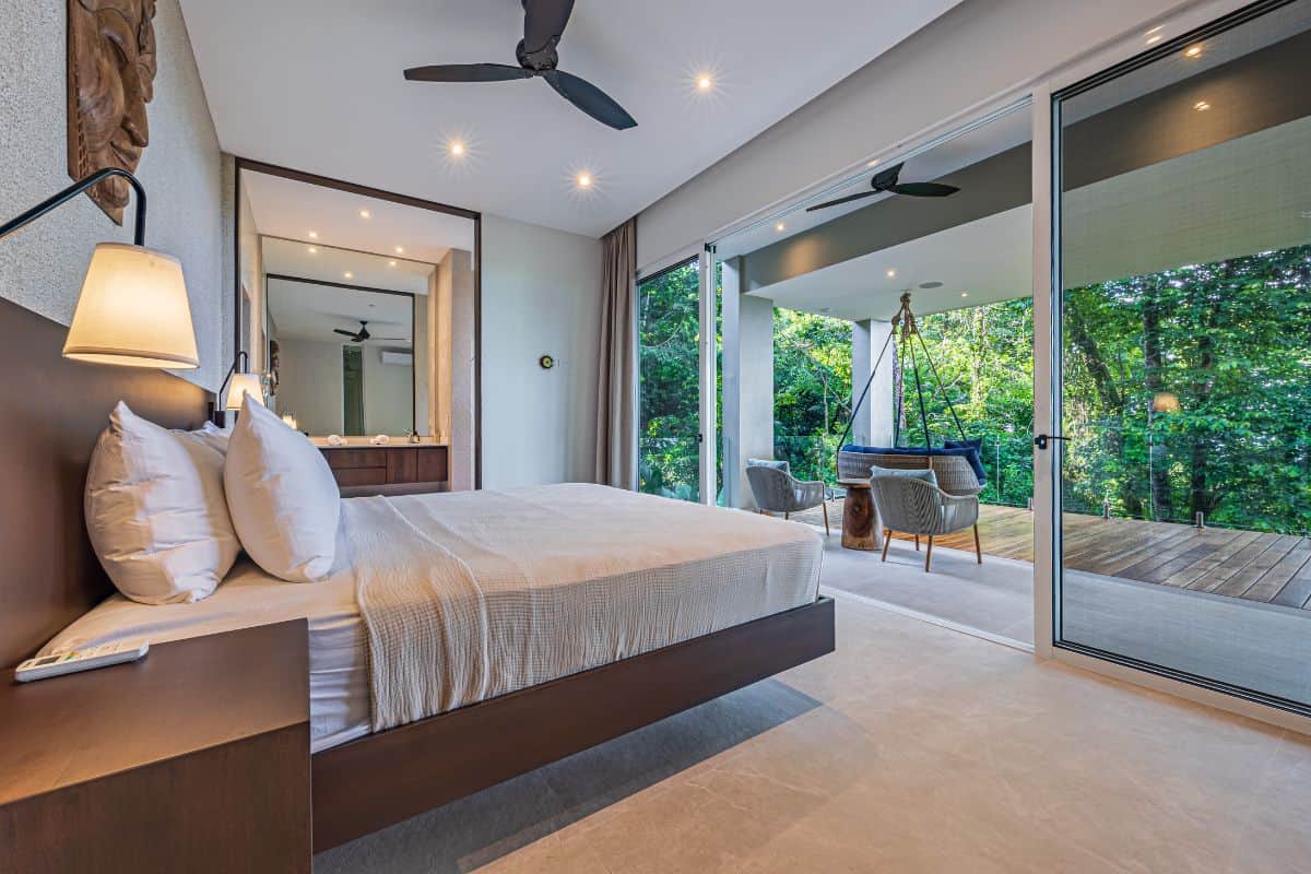 Bedroom with ensuite bathroom, walk-in closet and extensive patio with swing Bedroom with ensuite bathroom, walk-in wardrobe and terrace with outdoor bath tub at Villa Sueño.