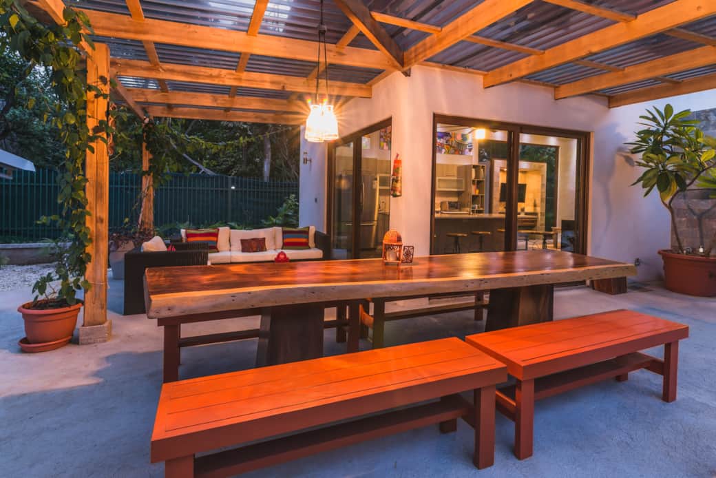 Massive handcarved dining table on the covered patio for hosting large group dinners