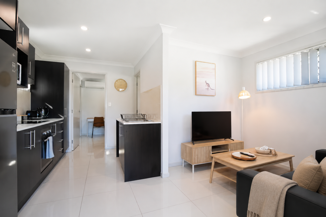 Living Area: Bright living space with comfortable seating and TV 