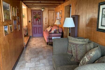 The loveseat in the hall is near two large windows - a perfect place to relax or read.