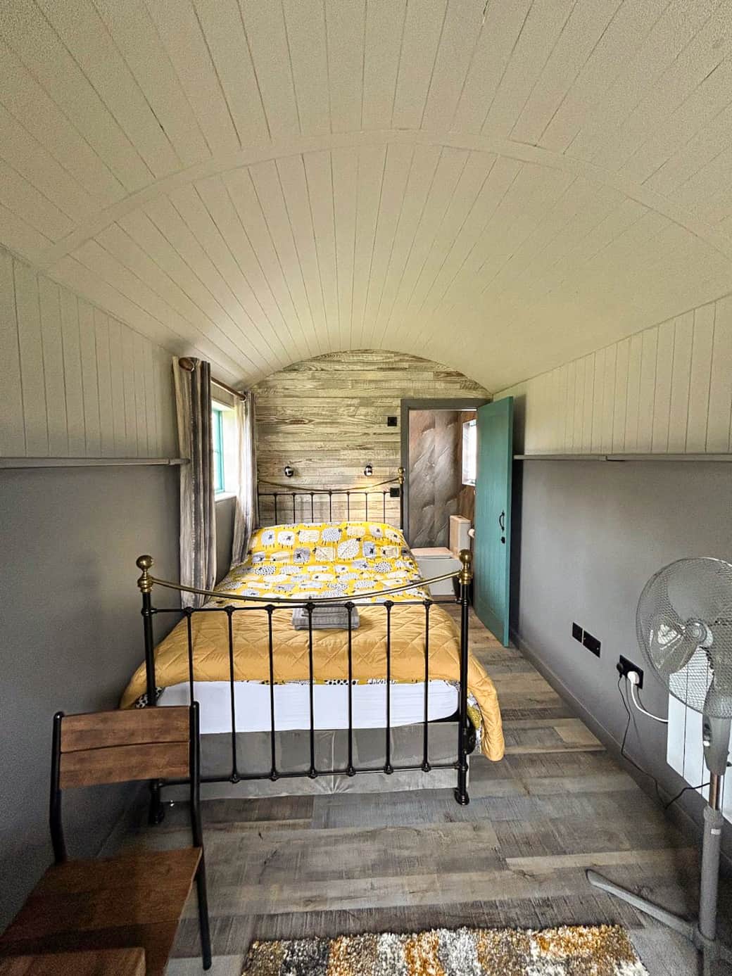 Bright and inviting bedroom area with cosy double bed and rustic finishes.