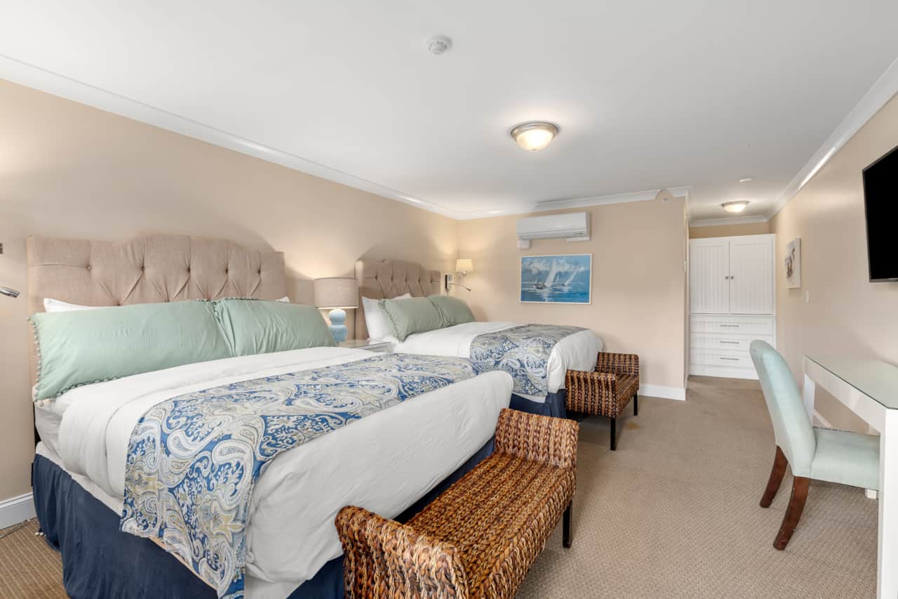 Large and spacious room with two queen beds, dedicated workspace, clean linens, and private entrance