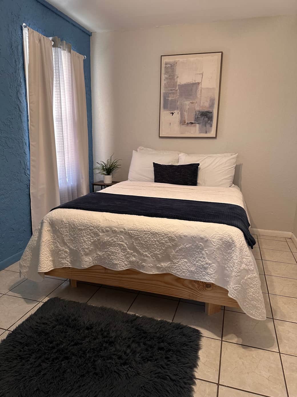 Bedroom with queen bed, big TV and nightstand charging station 