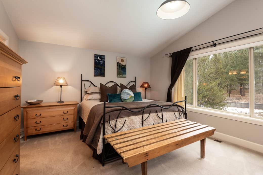 The primary main level bedroom has a king bed, walk in closet, soaking tub, double vanity and more