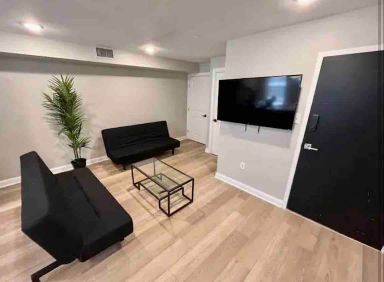 Cozy space featuring two comfy futon sofas and a 55-inch flat-screen TV! The kitchen boasts a stylish quartz island and a dining table—perfect for meals and gatherings. Enjoy your stay!