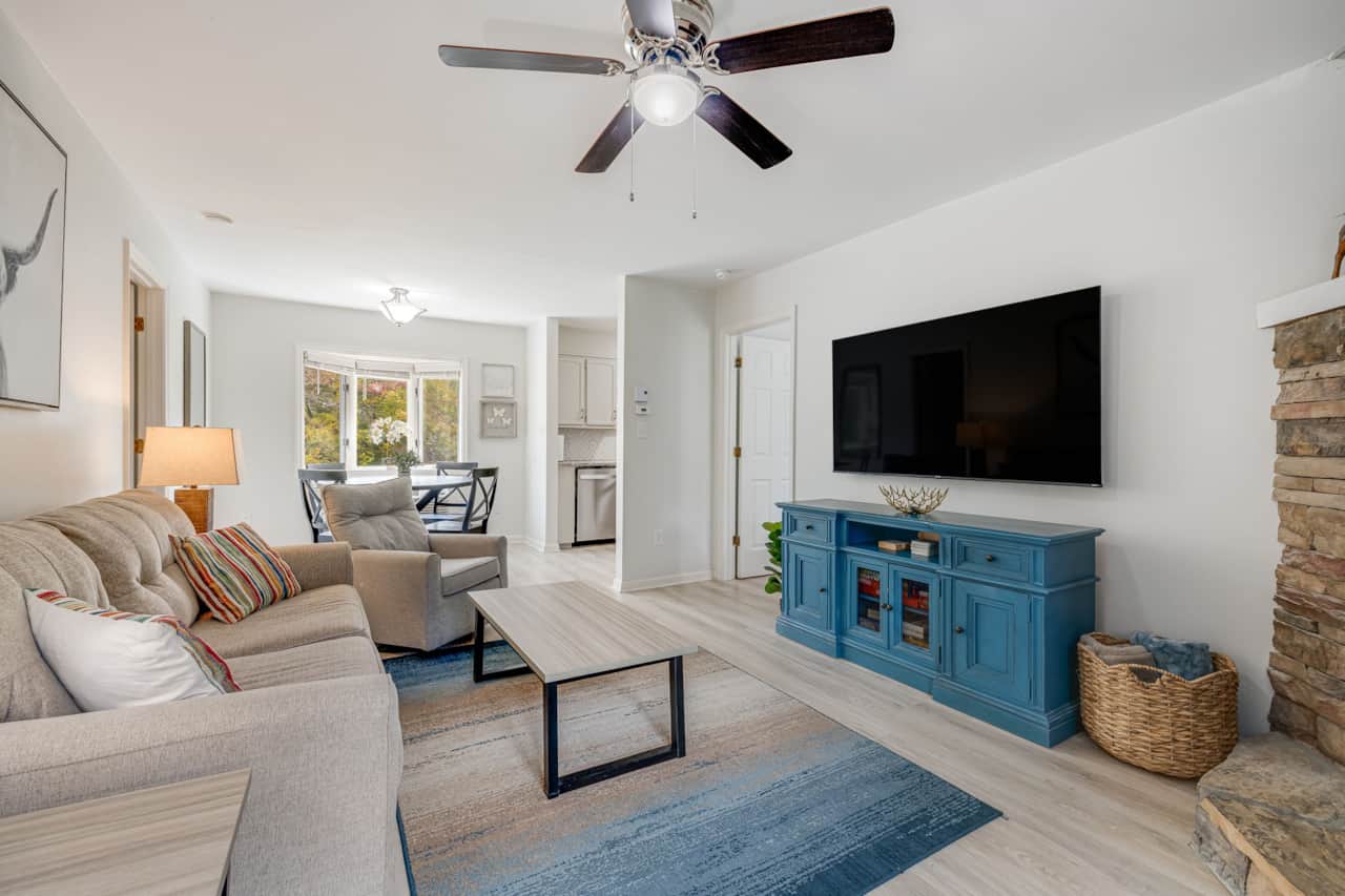 Open living and dining area with wall-mounted TV