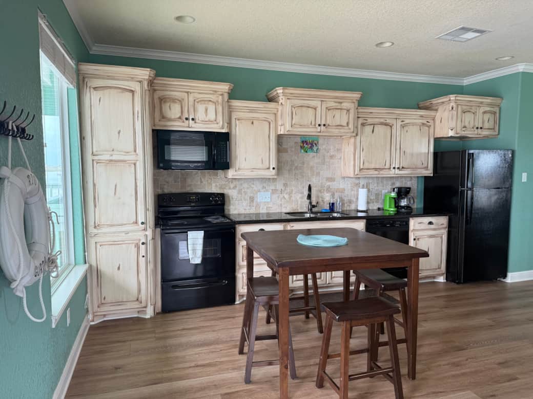 The kitchen has a fridge, oven and stove, microwave, dishwasher and two types of coffee makers. The kitchen has a fridge, oven and stove, microwave, dishwasher and two types of coffee makers.