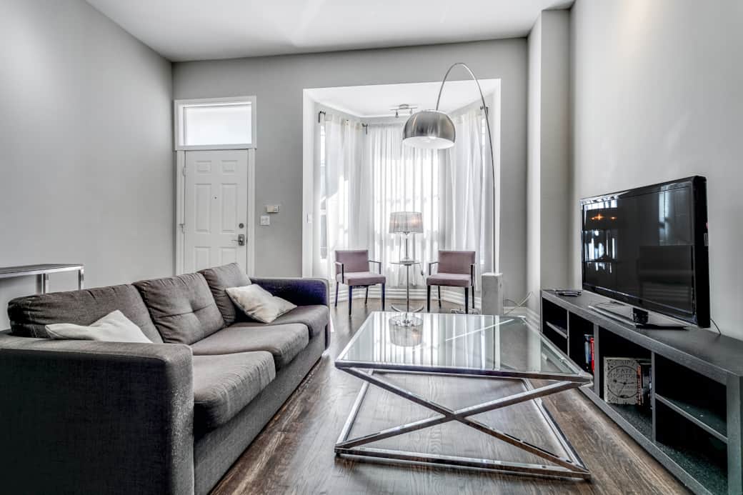 Illuminated and spacious living room in a Toronto high-end short-term rental.