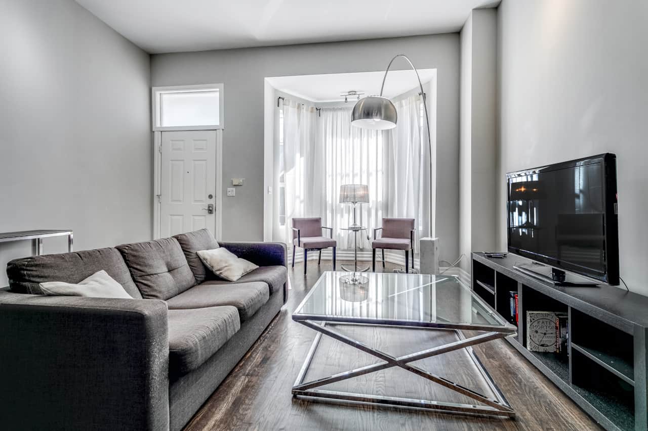 Illuminated and spacious living room in a Toronto high-end short-term rental.
