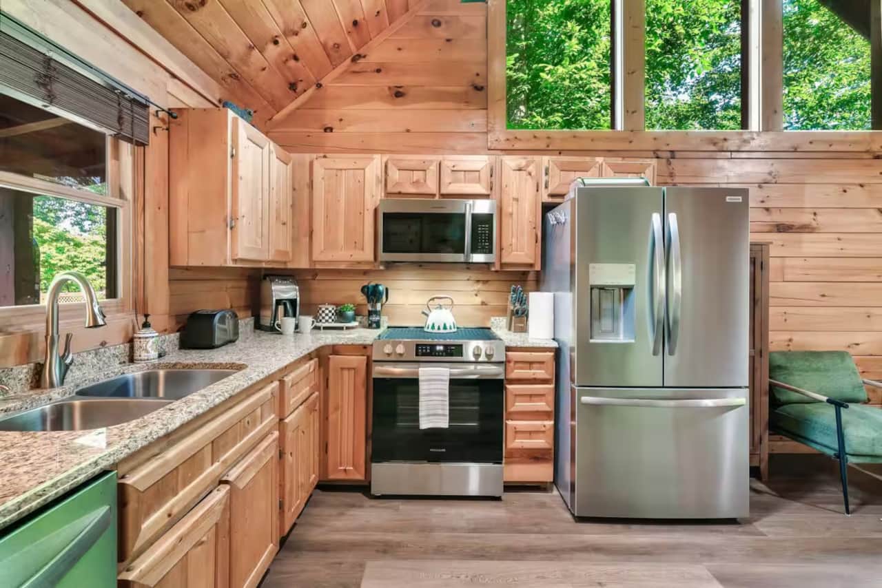 Fully equipped kitchen with stainless steel appliances, granite counters, and plenty of space