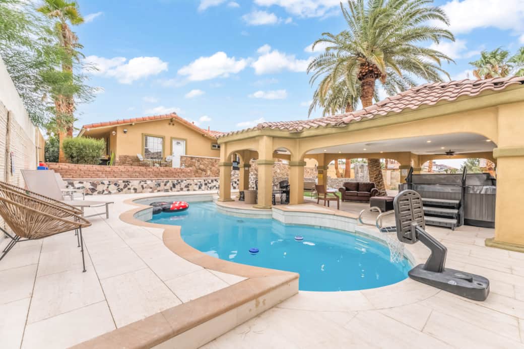 Relaxing backyard with a private pool, spa, shaded patio, outdoor lounge, & BBQ