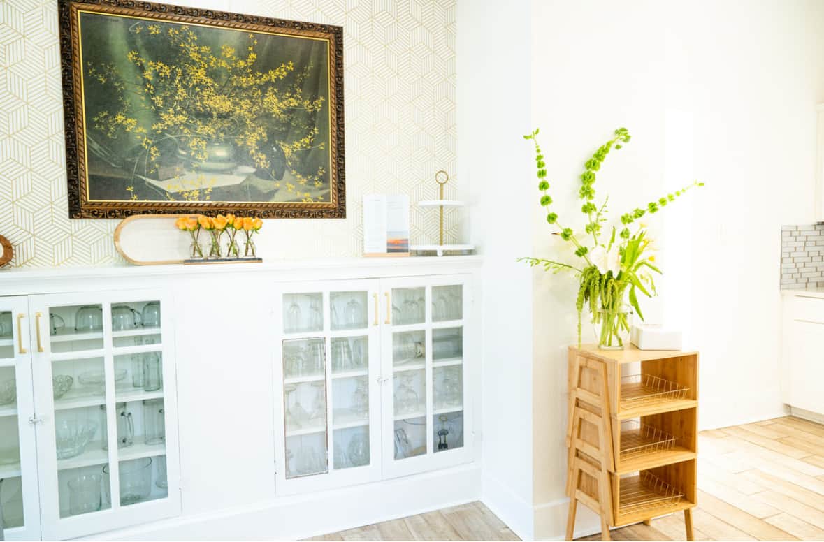 China cabinet with glassware, serving trays, champagne flutes, and entertaining essentials