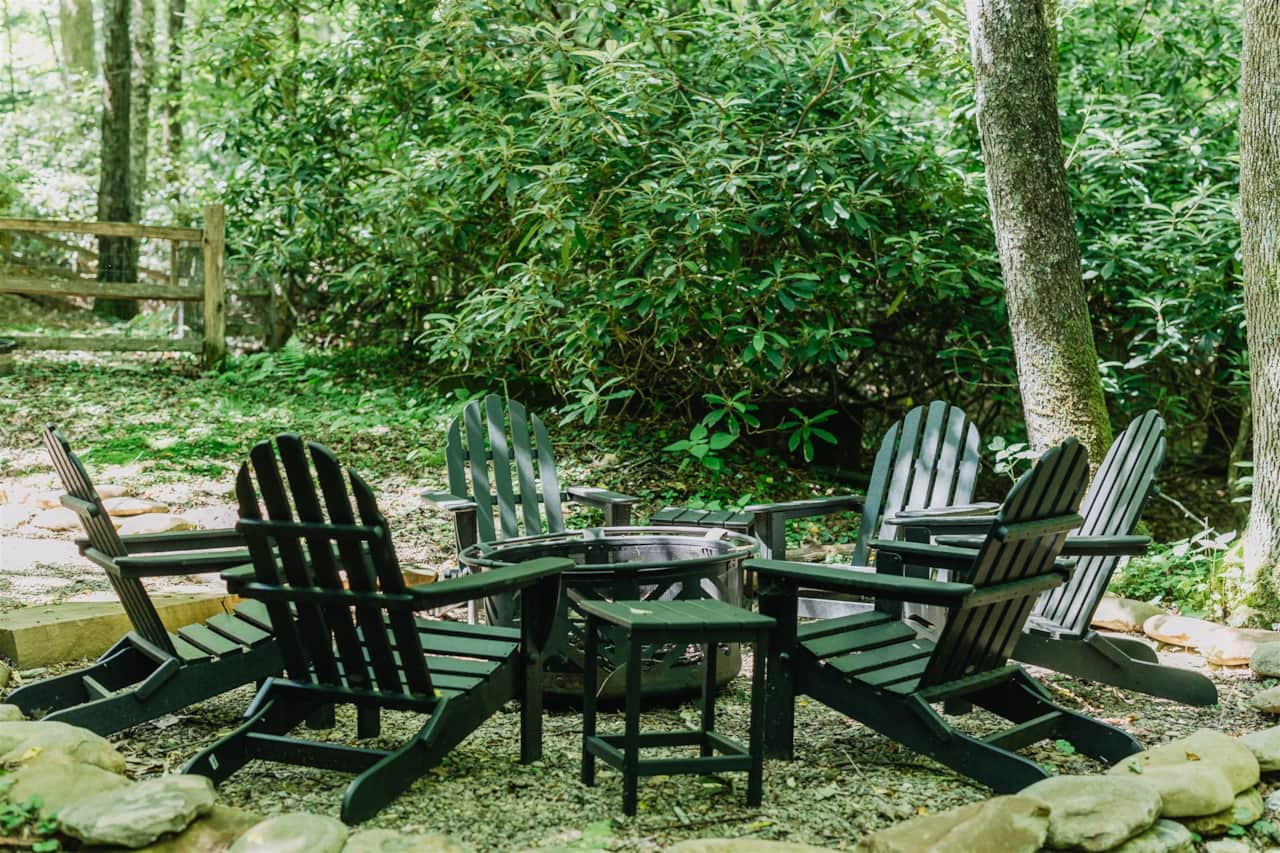New river rock firepit with adirondack chairs