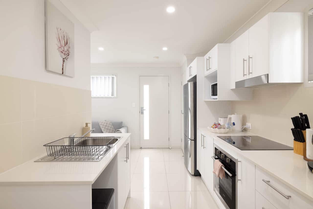 Kitchen: Sleek kitchen with ample storage, modern appliances 