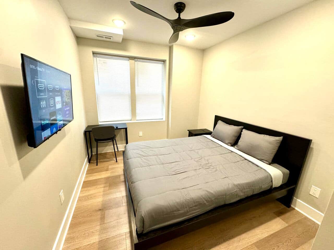 This comfortable bedroom includes a queen bed, flat-screen TV, ceiling fan, darkening curtains, a side table, USB charging, lamp, and a spacious closet for all your storage needs.