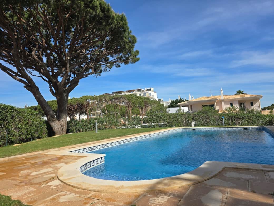 Shared outdoor pool set in a quiet garden, with plenty of space to relax and unwind.