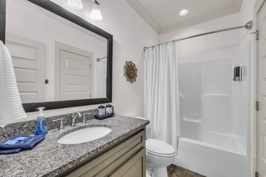 This main floor bathroom connects to both Bedroom #3 and the hallway.