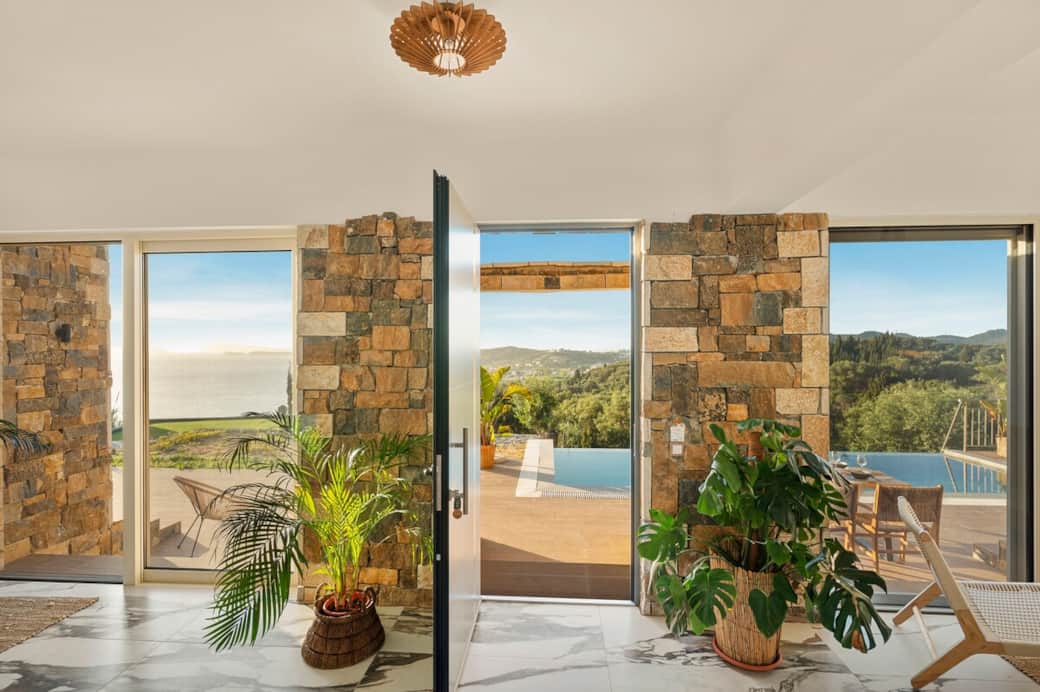 Panoramic windows flood the living room with breathtaking sea views and golden sunsets. Panoramic windows flood the living room with breathtaking sea views and golden sunsets.
