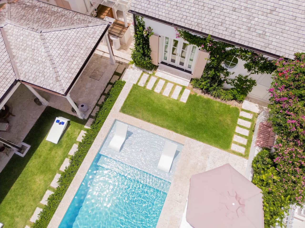 Angled aerial of Dunmore Cottage Harbour Island pool, outdoor kitchen, and Pool Cottage