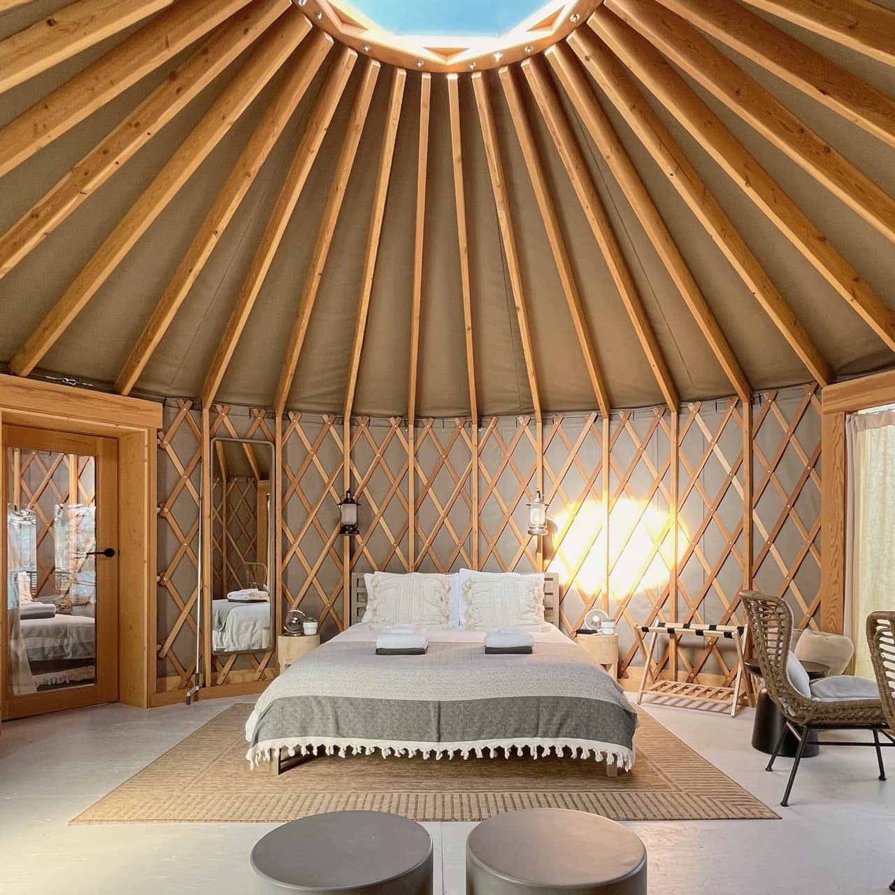 Both yurts have douglas fir rafters that rise towards a central skylight; beautiful craftsmanship.