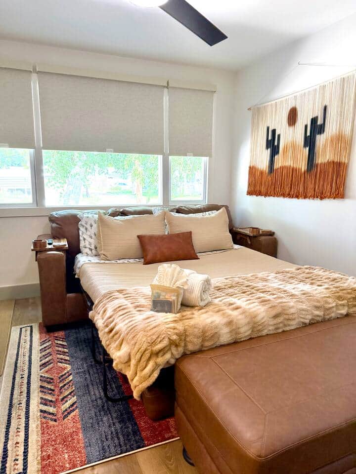 Surprise! Our couch transforms into this dreamy sleeper setup! With soft linens, fluffy throws, & a little welcome bundle on top, it’s the perfect spot to cozy up after a day of exploring. Just message us in advance to have the sofa bed pre-set!