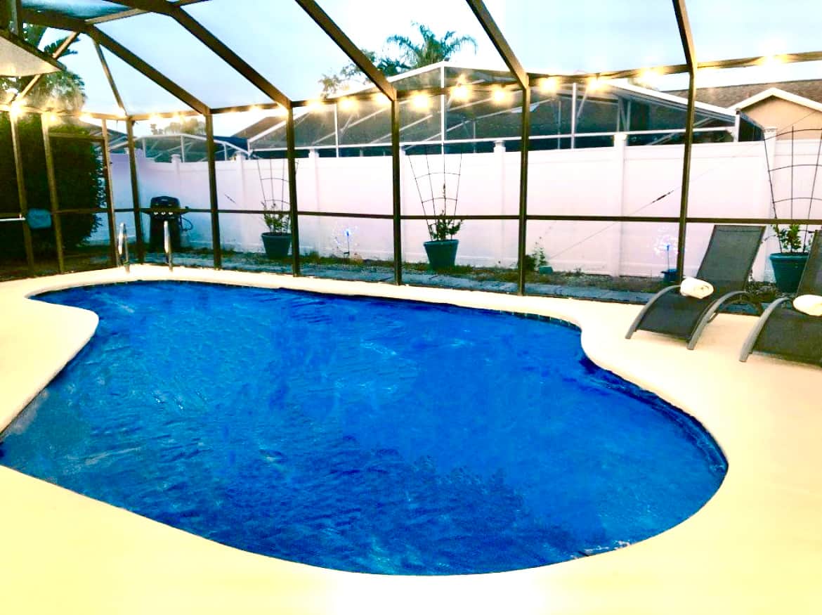 As the sun sets, the outside lighting allows for the pool area to continue being used