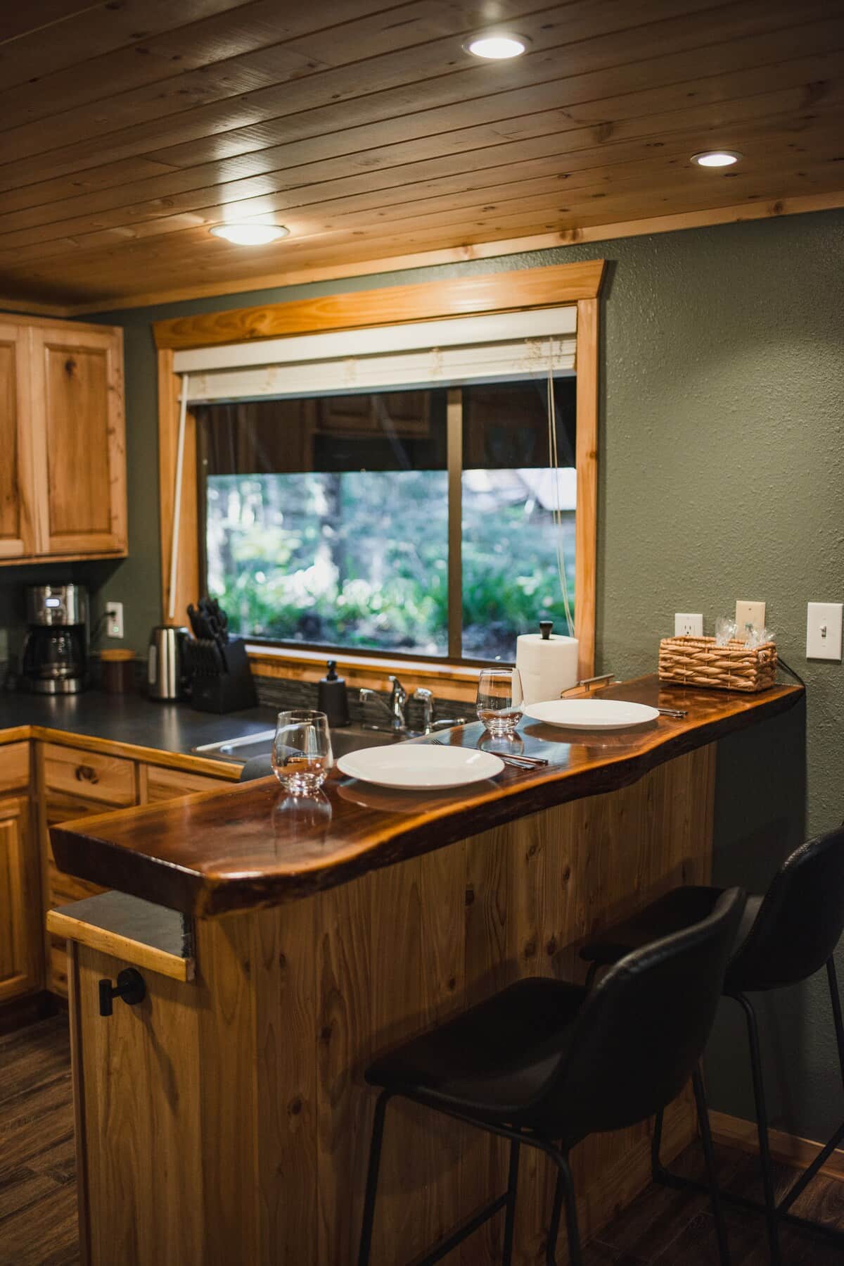 The fully equipped kitchen includes an electric stove, Ninja air fryer, toaster, waffle maker, coffee pot, French press, and electric tea kettle for all of your cooking needs.