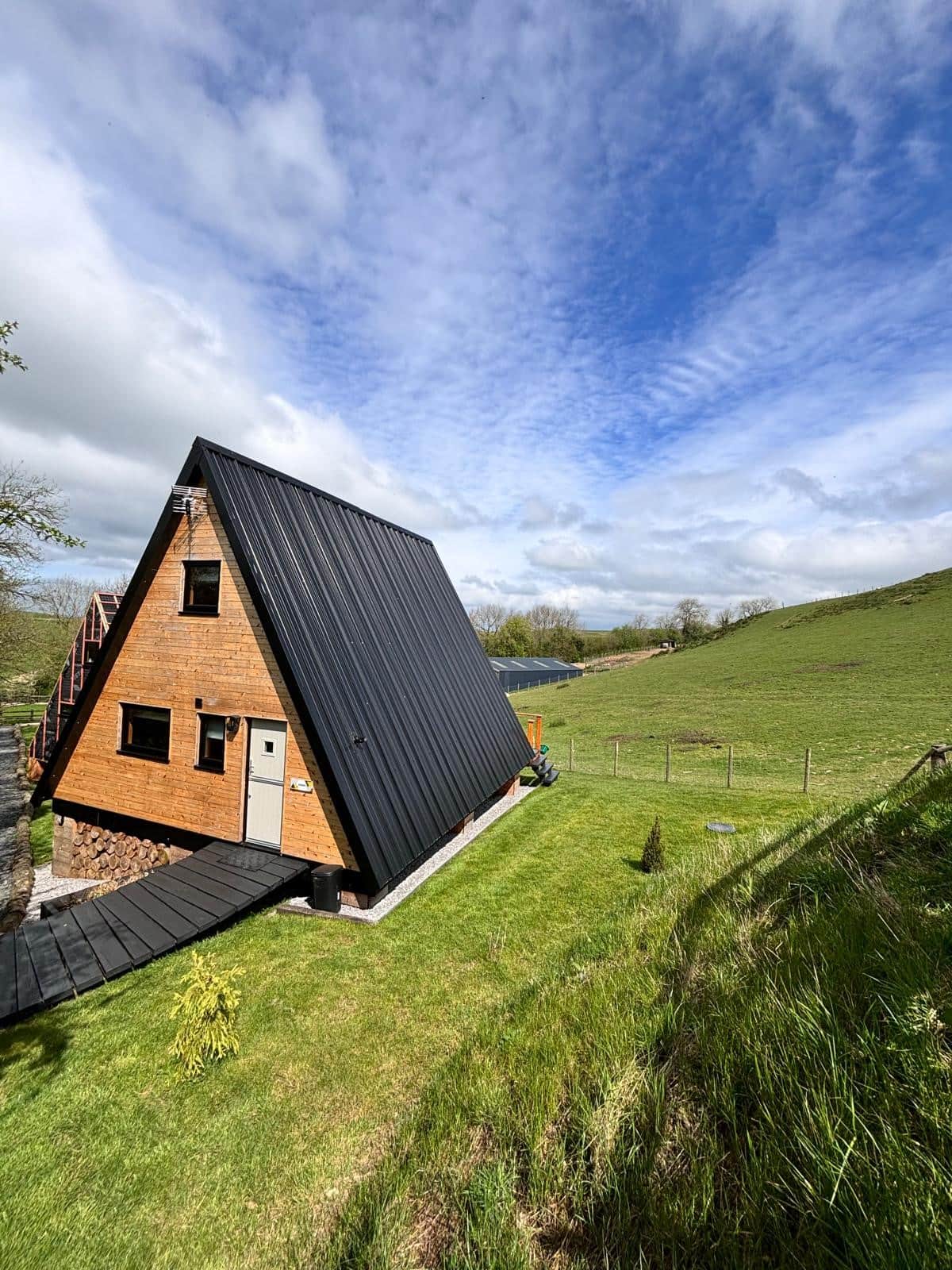 Sigrid Lodge amidst lush greenery, under a cloudy sky.