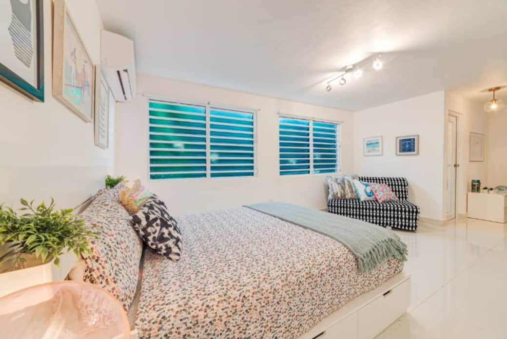 A spacious master bedroom with a queen bed and ensuite bathroom.