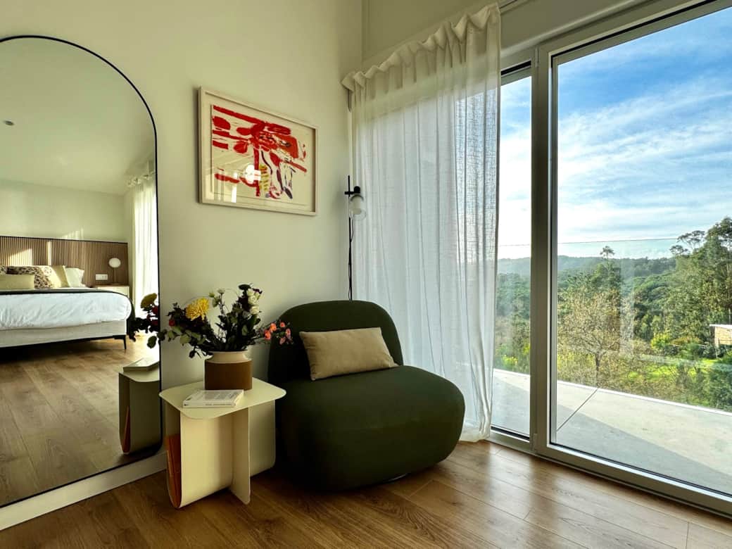 Cozy reading corner with forest views and natural light.