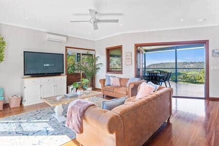 Light filled living room with access to two outdoor areas.