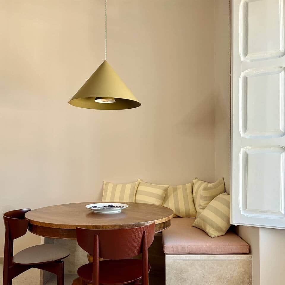 The dining space features a walnut table, sumptuous textiles & unique lighting
