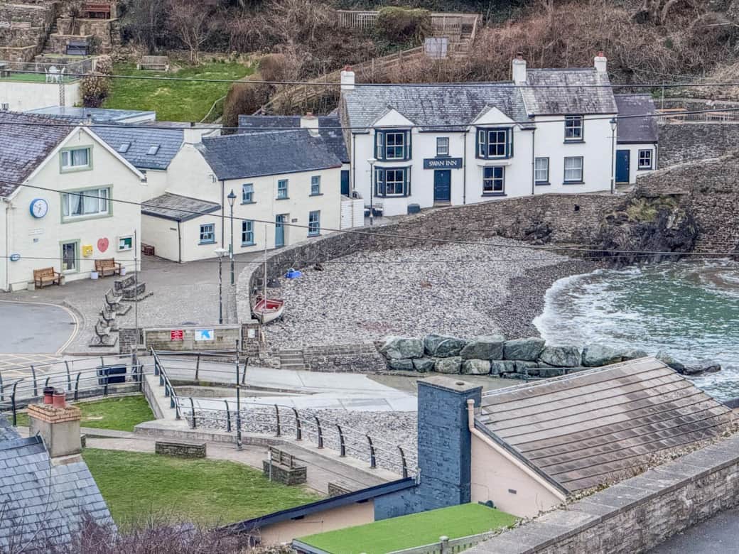 View from the secure garden down to The Swan Inn, and the Little Haven beach at high tide. 